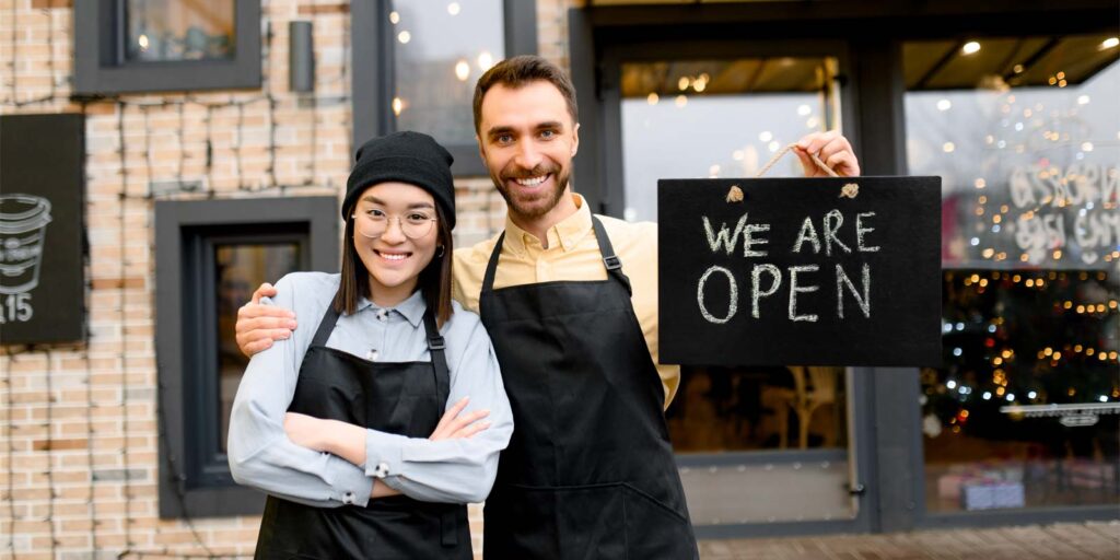 business owners opening their shop after receiving an SBA loan