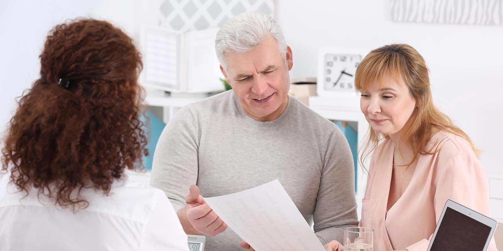 insurance agent explaining death benefit policy to couple