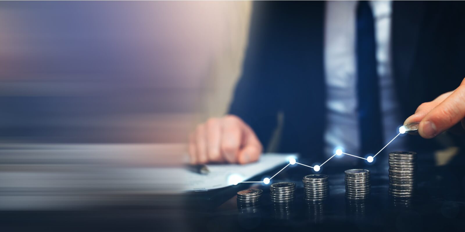 putting money coin stack with growing business graph