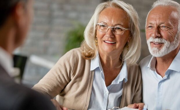 happy senior couple having a meeting with real estate agent