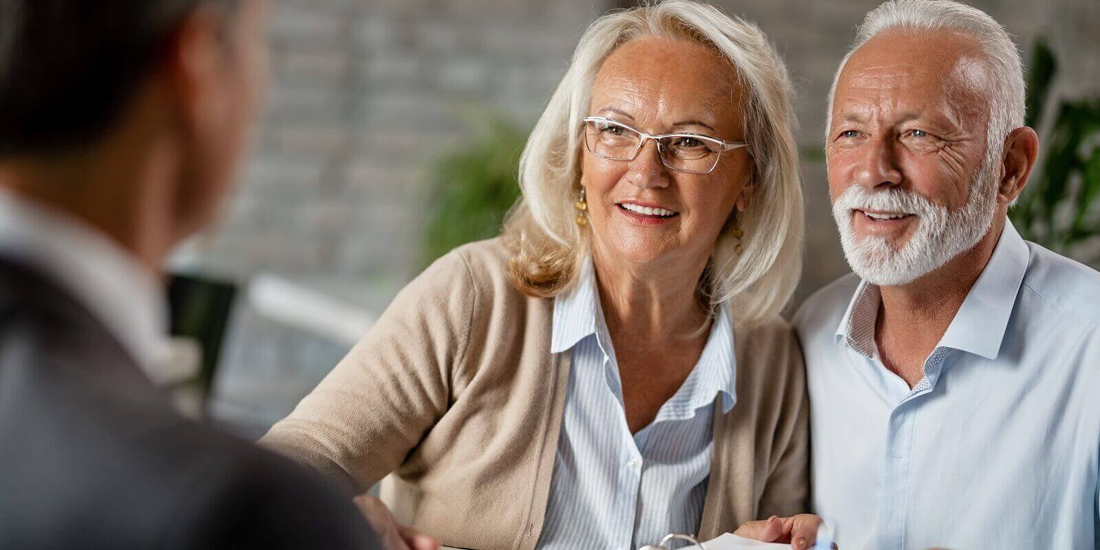 happy senior couple having a meeting with real estate agent