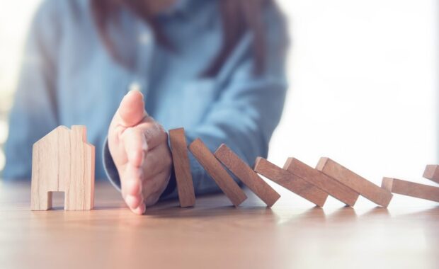 hand stopping risk the wooden blocks from falling on house