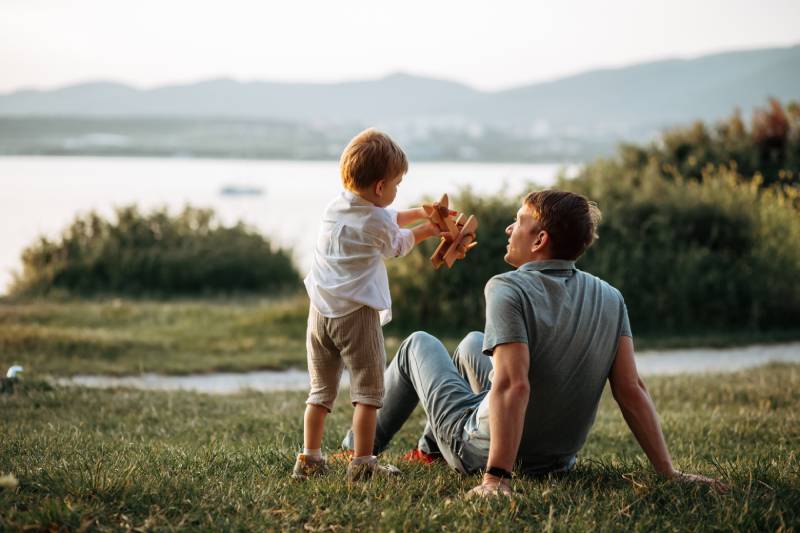 A Child With His Dad Who Is Protected By A Universal Life Insurance Policy