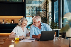 Happy Retired Couple Checking Their MYGA Investment Growth