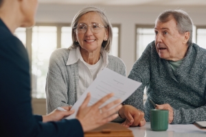 Senior Couple Talking to Financial Advisor at End of Fixed Annuity Term