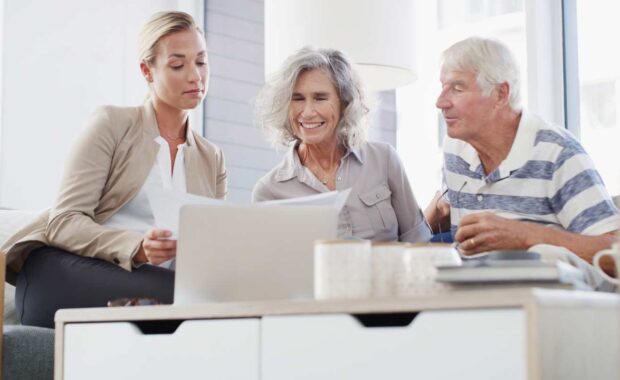 Finacial Advisor Showing Fixed Annuity Options to Senior Couple