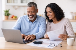 Mid Age Couple Checking Fixed Annuities Plans Before Retirement