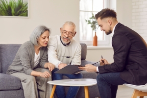 Elderly Couple Discussing Annuity Options with Financial Advisor as Retirement Strategy