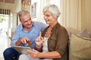 Happy Elderly Couple Checking MYGA Investment Option for Retirement on Laptop