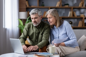 Pre-Retiree Couple Reviewing Fixed Annuity Options on Laptop