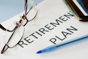 Retirement Plan Text Written on White Paper with Specs and Pen
