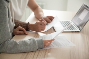 Couple Comparing MYGA and Other Options with Documents and Laptop
