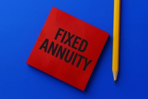 Red Sticky Note with Words Fixed Annuity and Yellow Pencil