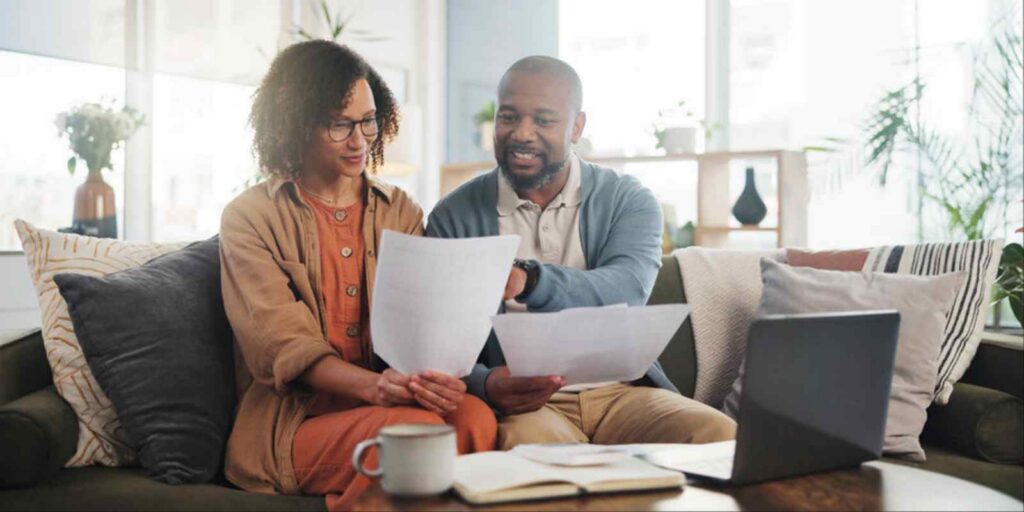 Couple Comparing MYGA and Fixed Deposit Documents for Investment