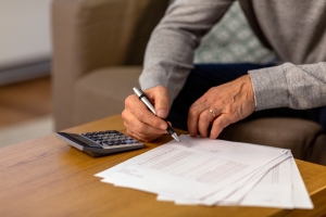 Man Comparing the- MYGA Return Document with Calculator Results