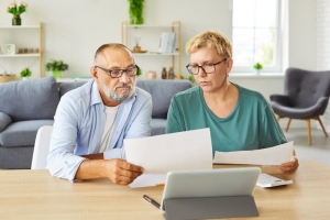 Senior Couple Reviewing Pros and Cons of MYGA Using Documents
