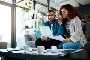 Smiling Couple with Financial Documens Doing Retirement Planning with MYGA
