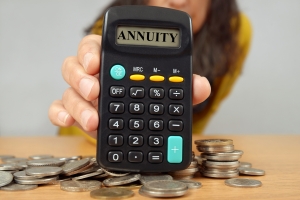 Woman Showing Calculator with Text Annuity Near Coins