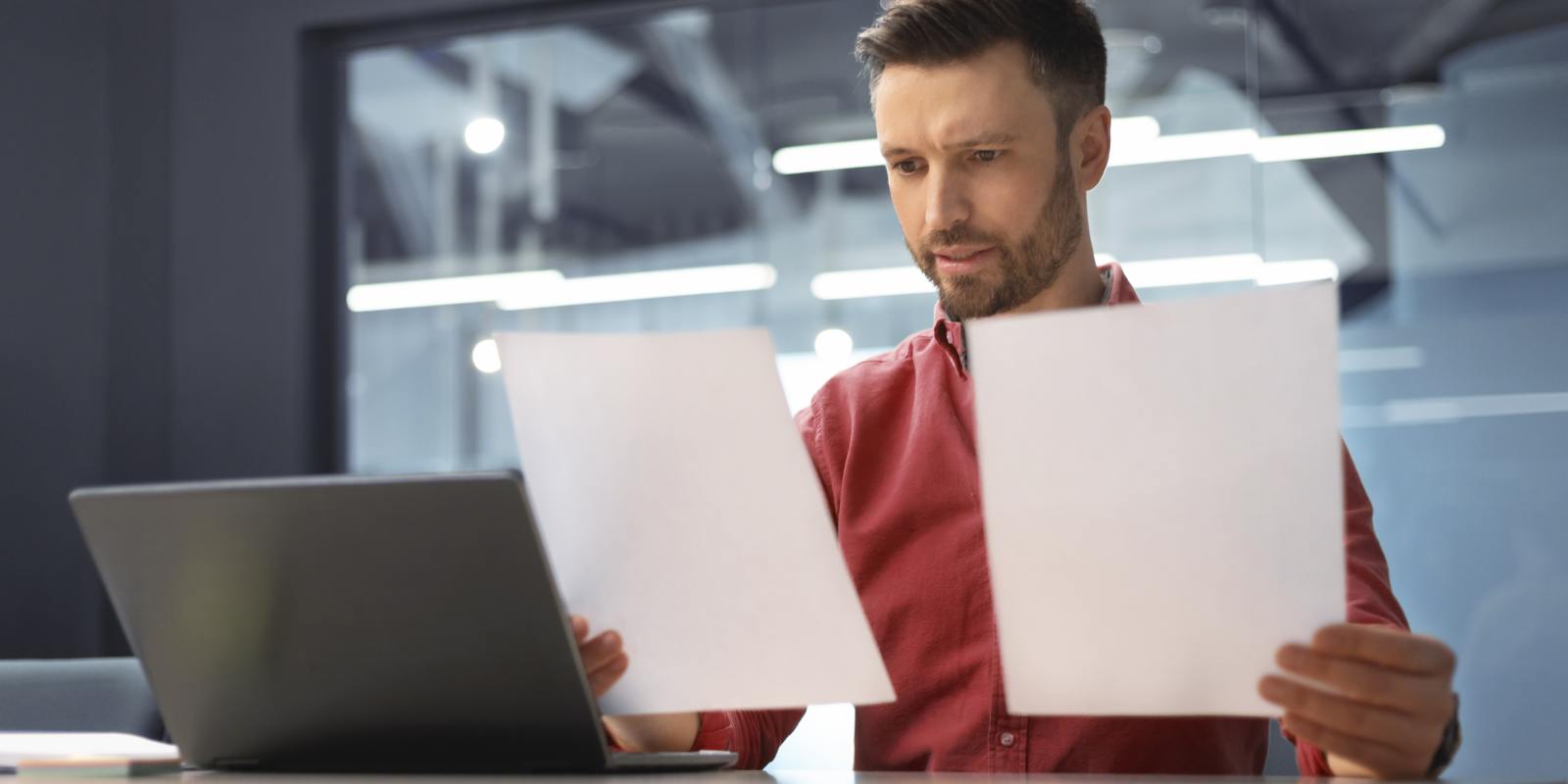 Man Comparing MYGA Documents at His Desk