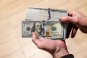 Person Holding Cash from MYGA Penalty-Free Withdrawals