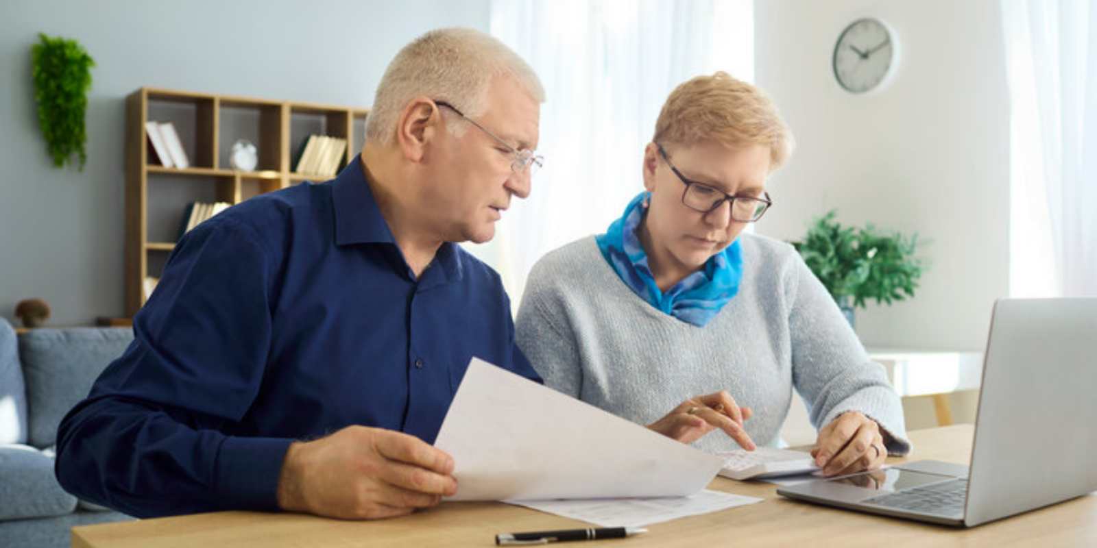 Senior Couple Calculating MYGA and Fixed Deposit Returns with Calculator