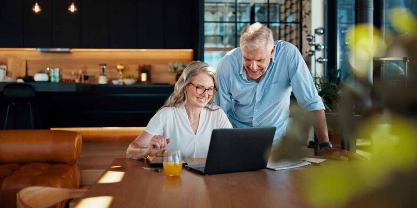 Senior Couple Smiling While Reading Benefits of MYGA