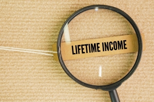 A Magnifying Glass and A Paper Tag with The Words Lifetime Income