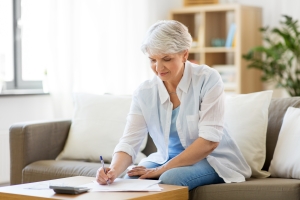 Woman Calculating Saving for Annuities in Retirement Planning